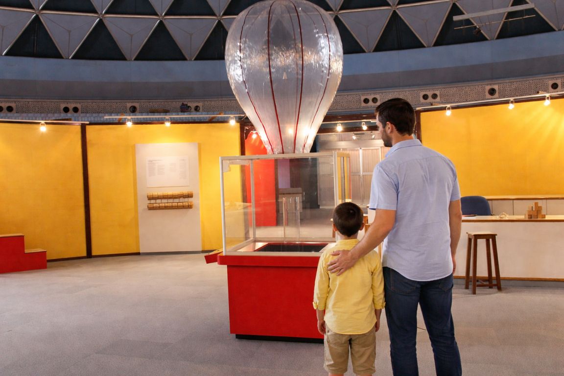 Father and child exploring interactive exhibit at Children’s Museum in Muscat during a tour with Oman Muscat Tours