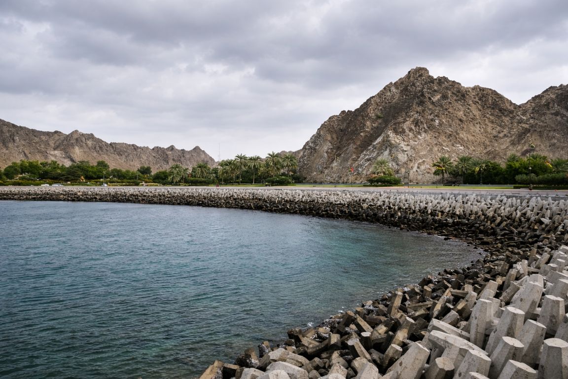 Scenic Mutrah Corniche coastline with sea wall and mountains in Oman explored during a guided tour with Oman Muscat Tours