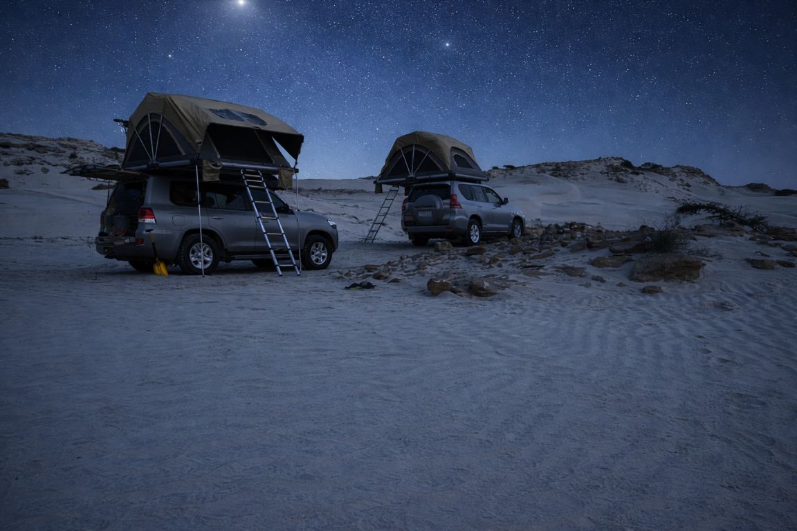 Night camping in Sugar Dunes with 4x4 vehicles and rooftop tents in the desert explored during an Oman Muscat Tours trip